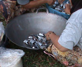 Women’s group members make fish curry for community activities. They get the fish from the coastal area of the community.