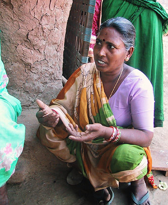 Figure 13. A woman in Punukula village explains the benefits of Non-Pesticide Management for her quality of life.